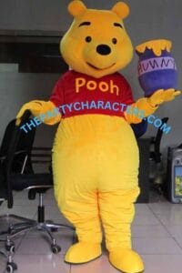 Costumed Winnie the Pooh character standing indoors in a red Pooh shirt, yellow fur, and a purple honey pot labeled 'HUNNY' in one hand. Watermark across the midsection reads 'THEPARTYCHARACTERS.COM'.